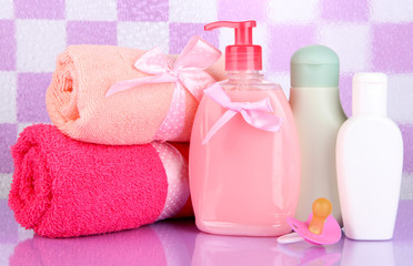 Obraz na płótnie Canvas Baby cosmetics and towels in bathroom