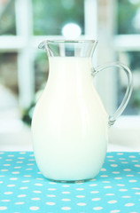 Pitcher of milk on table in room