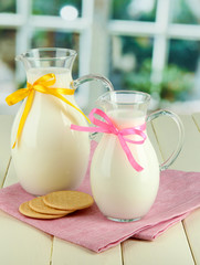 Pitchers of milk on table in room