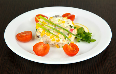 Small portion of food on big plate on wooden table