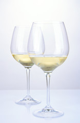 Two glasses of white wine, isolated on white