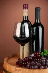 Fotobehang Composition of wine bottle, glass of red wine, grape © Africa Studio
