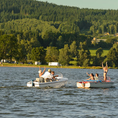 Young people having fun on motorboats