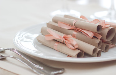 Twisted letters on a white plate. dinner or wedding