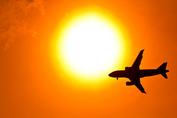 Aircraft on sunset background