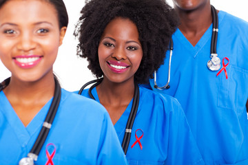 african healthcare workers with red ribbon
