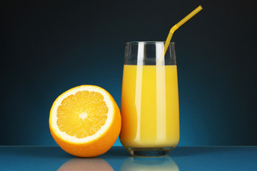 Delicious orange juice in glass and orange next to it