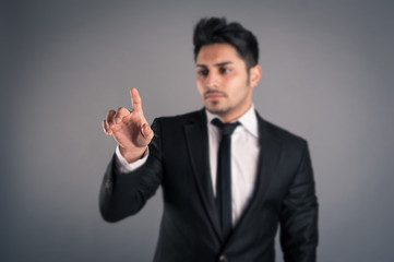 Young businessman indicating with finger.