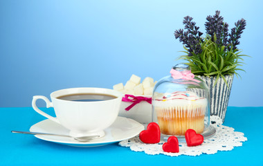 Cupcake on saucer with glass cover, on color background