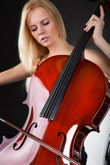 Beautiful young woman playing cello