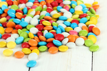 Fototapeta na wymiar Colorful candies on white wooden background