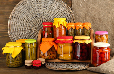 Different conservations on shelves on wooden background