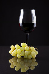 Still Life Of Wine And Grapes On Black Background