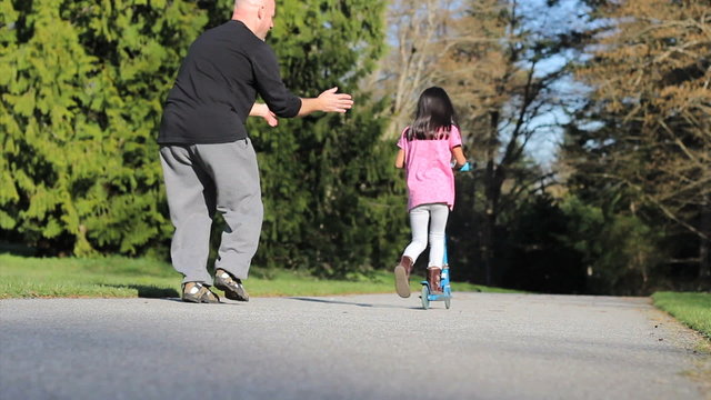 Nervous Dad Helps Daughter Ride Scooter-Without Helmut