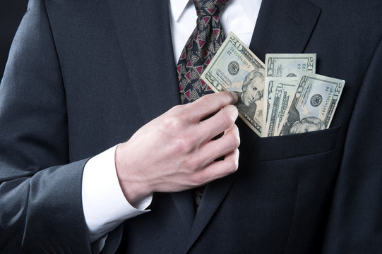 Concept photo showing businessman pulling out money from pocket