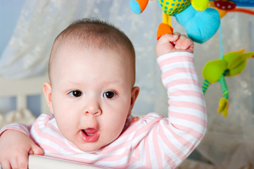 Baby in children's to a bed