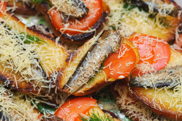 bread with sprats, tomato and cheese. delicacy gourmet food back