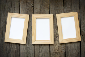 Old empty photos frame on vintage planks background concept