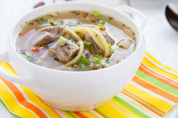 nutritious meat soup in a white tureen