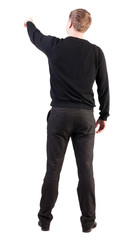 Fototapeta premium Back view of pointing young business men in black sweater