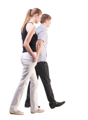 Back view of walking  young couple
