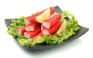 Crab sticks with lettuce leaves and lemon