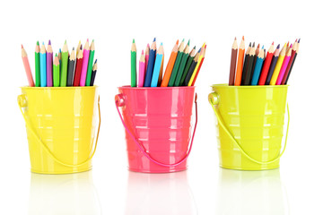 Colorful pencils in three pails isolated on white