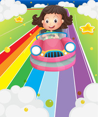 A little girl riding in a pink car