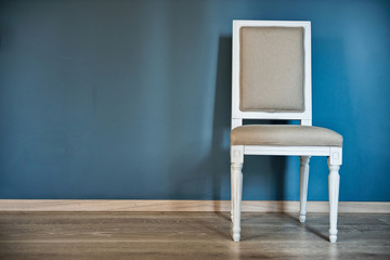 White chair near the blue wall