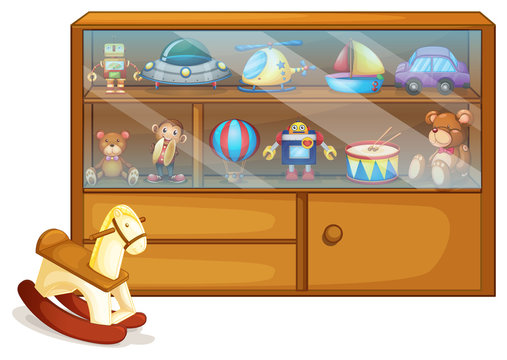 A horse toy beside a wooden cabinet