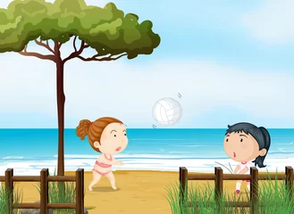 Deurstickers Twee kleine meisjes volleyballen op het strand © GraphicsRF