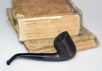 Worn books and tobacco pipe