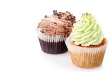 two cupcakes with cream isolated on white background with copysp