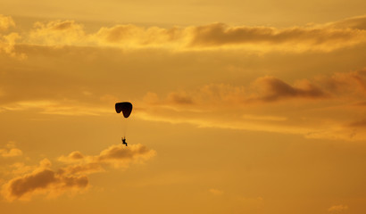 Paragliding is flying across the night sky
