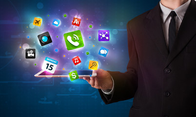 Businessman holding a tablet with modern colorful apps and icons