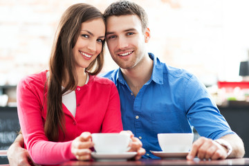 Fototapeta premium Couple sitting in cafe drinking coffee