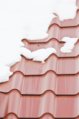 Melting snow on the roof with a metal roof