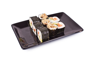 sushi rolls on black plate