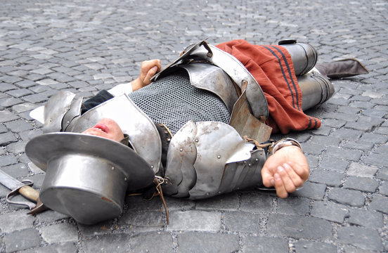medieval warrior lying dead on the ground