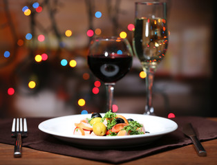Tasty salad on dark background with bokeh  defocused lights