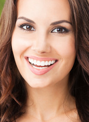 Happy smiling young woman, outdoors