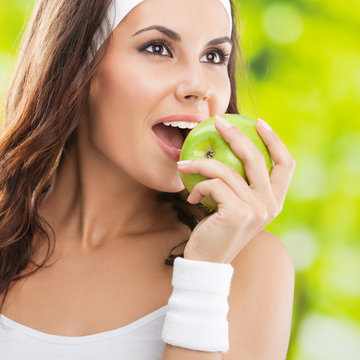 Woman In Fitness Wear With Apple, Outdoors