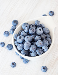 White bowl cup with fresh ripe blueberries