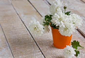 Bunch of bright white chrysanthemum flowers on wooden background