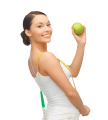 sporty woman with apple and measuring tape