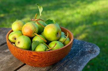 fresh pears in a wooden bowl