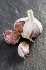 Garlic bulb and cloves on gray background