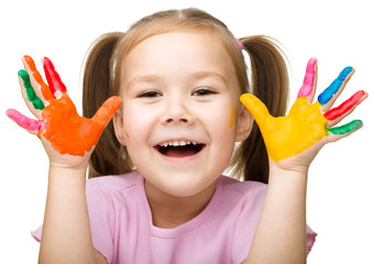 Portrait of a cute girl playing with paints