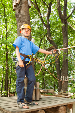 Young boy with equipment climber happy success.