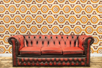 Retro styled image of an old sofa against a vintage wallpaper